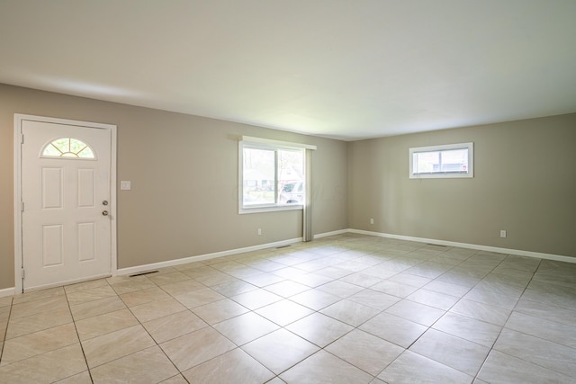 foyer with light tile patterned floors and baseboards