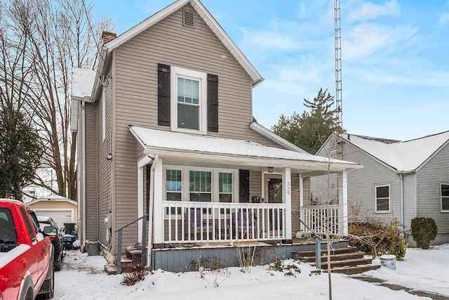 view of front of property featuring a garage and a porch