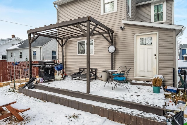 snow covered house featuring a pergola