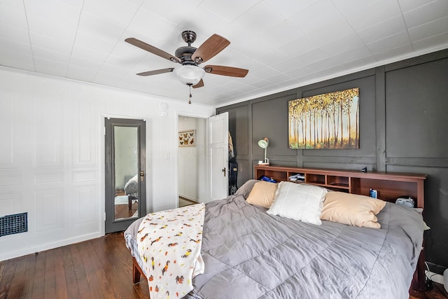 bedroom with ceiling fan, dark wood-type flooring, and ornamental molding