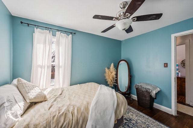 bedroom with ceiling fan and dark wood-type flooring