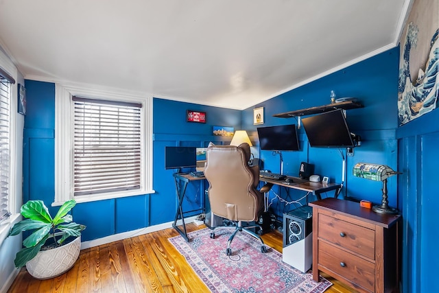 office area featuring hardwood / wood-style floors, ornamental molding, and lofted ceiling