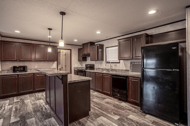 kitchen featuring decorative light fixtures, a kitchen island, black appliances, dark wood-type flooring, and dark brown cabinets