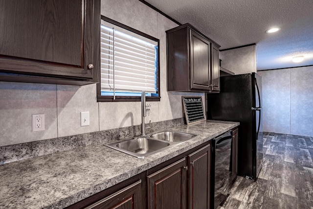 kitchen featuring dark hardwood / wood-style floors, sink, dark brown cabinetry, a textured ceiling, and black refrigerator