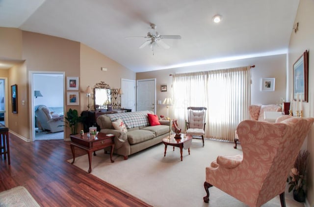 living room featuring ceiling fan, dark hardwood / wood-style floors, and vaulted ceiling