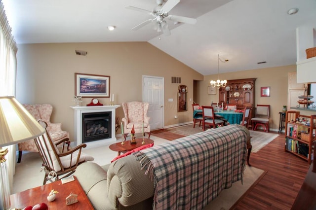 living room featuring ceiling fan with notable chandelier, lofted ceiling, and light wood-type flooring