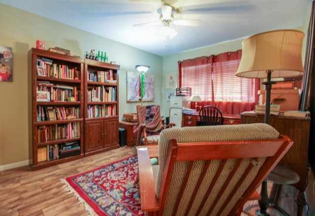 living area with ceiling fan and wood-type flooring