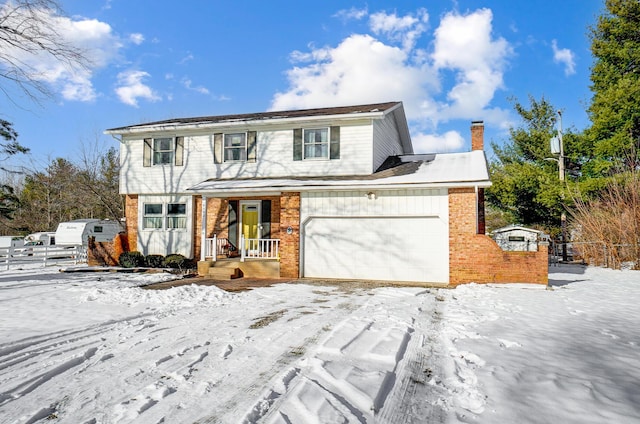 front of property featuring covered porch and a garage