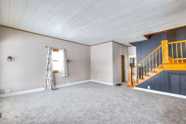 spare room featuring wood ceiling, crown molding, and carpet flooring