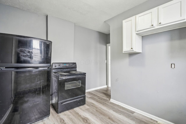 kitchen featuring light wood-type flooring, white cabinets, a textured ceiling, and black appliances