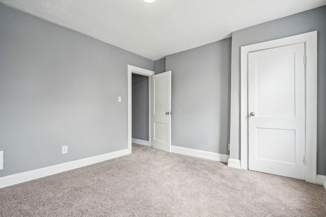 unfurnished bedroom with light carpet