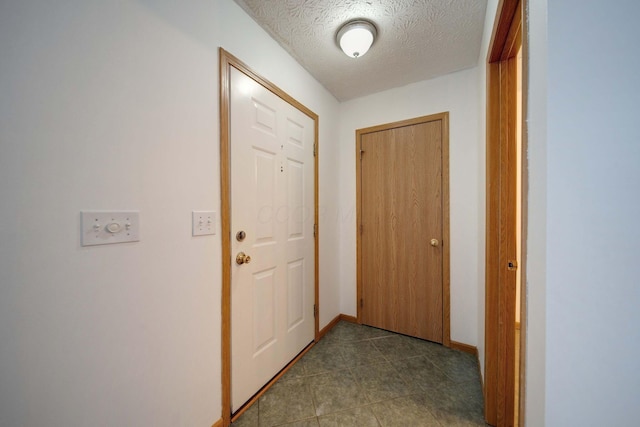 hall with a textured ceiling