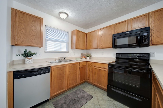 kitchen featuring black appliances, sink, a textured ceiling, and light tile patterned flooring