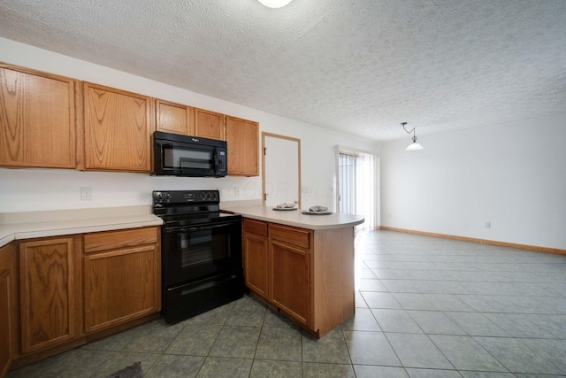 kitchen featuring a textured ceiling, pendant lighting, kitchen peninsula, and black appliances