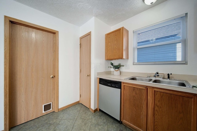 kitchen featuring sink, a textured ceiling, and dishwasher