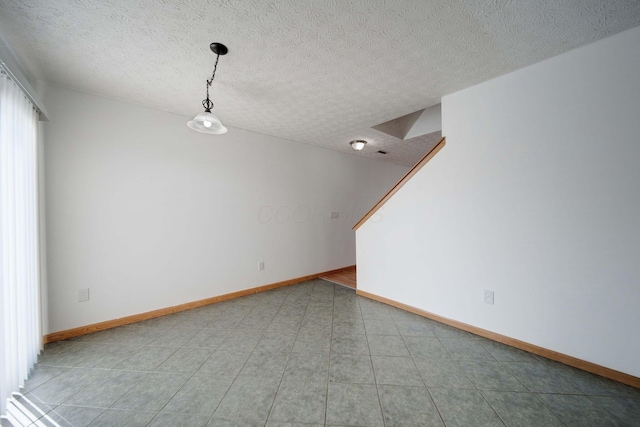 empty room featuring a textured ceiling