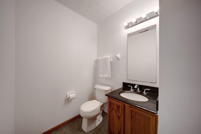 bathroom featuring a textured ceiling, tile patterned floors, vanity, toilet, and vaulted ceiling