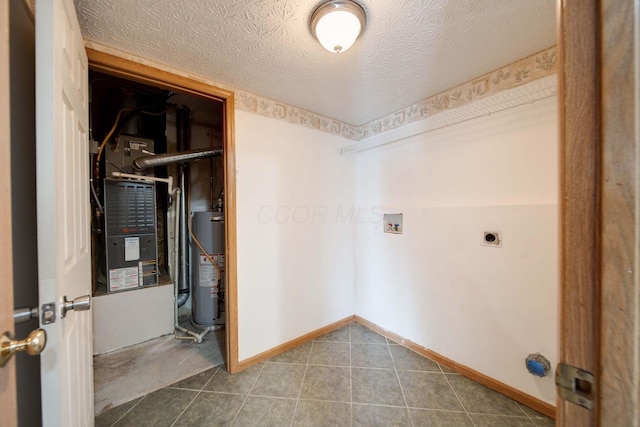 laundry area with water heater, washer hookup, hookup for an electric dryer, and a textured ceiling