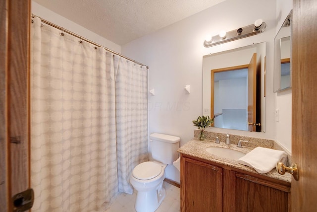 bathroom with toilet, a textured ceiling, and vanity