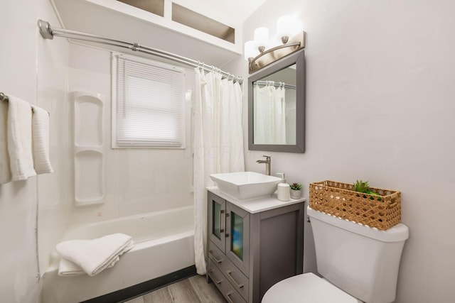 full bathroom with wood-type flooring, vanity, shower / bathtub combination with curtain, and toilet