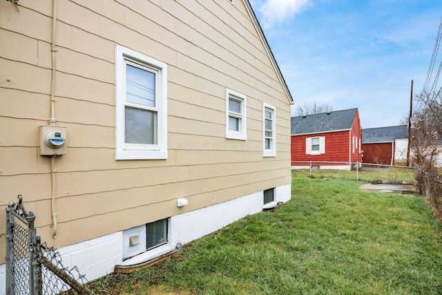 view of side of home featuring a yard