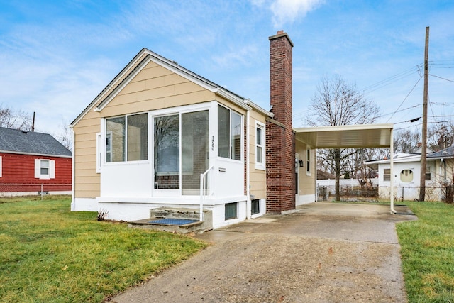 exterior space with a carport and a front lawn