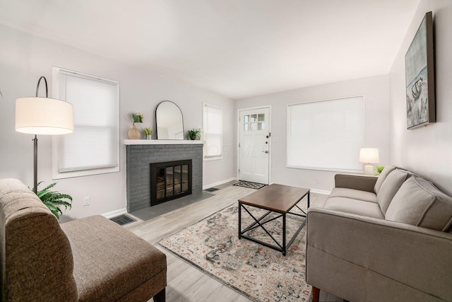 living room with a fireplace and light hardwood / wood-style floors