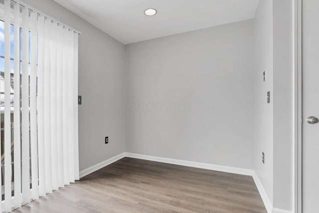 empty room with hardwood / wood-style flooring