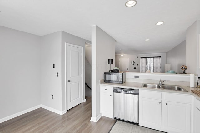 kitchen with light hardwood / wood-style floors, dishwasher, white cabinets, and sink