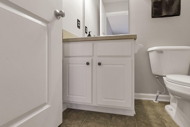 bathroom featuring toilet, tile patterned floors, and vanity