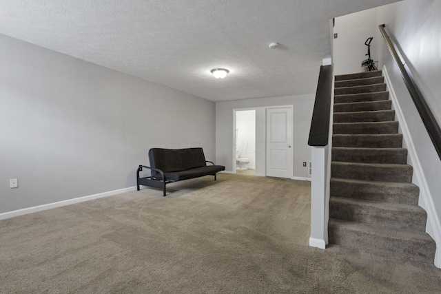 unfurnished room with carpet floors and a textured ceiling