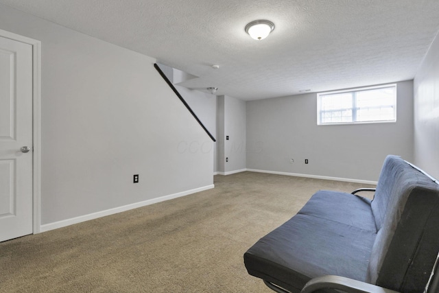 living area featuring a textured ceiling and light carpet