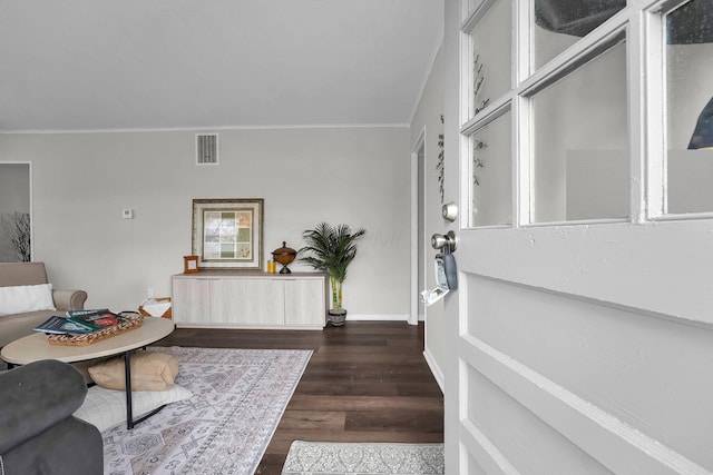 entrance foyer featuring ornamental molding, wood finished floors, visible vents, and baseboards