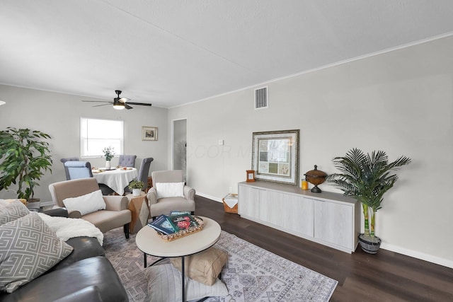 living area with dark wood-style flooring, visible vents, ceiling fan, and baseboards