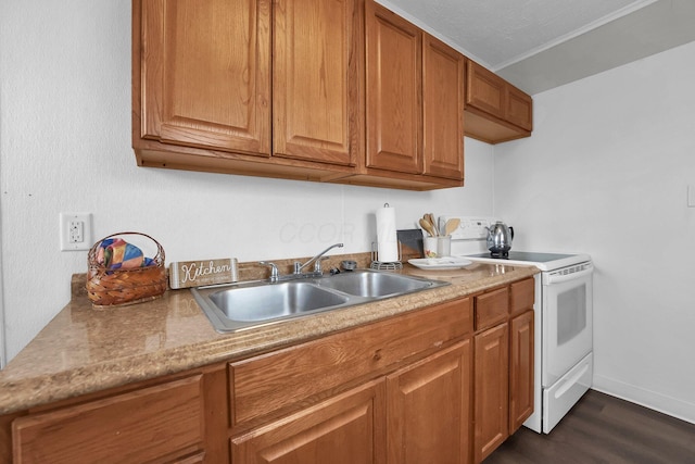 kitchen with dark wood-style floors, electric range, brown cabinetry, and a sink