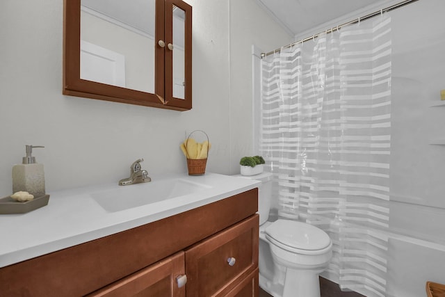 bathroom featuring curtained shower, vanity, and toilet