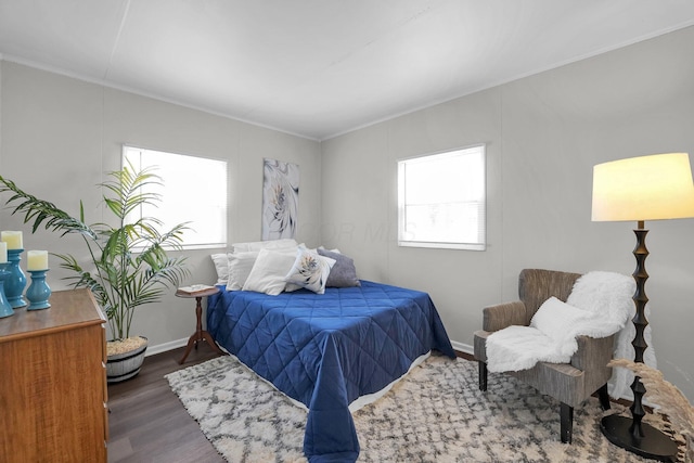 bedroom featuring wood finished floors and baseboards