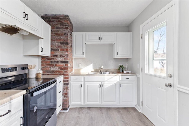 kitchen featuring white cabinetry, sink, stainless steel range with electric stovetop, a textured ceiling, and light hardwood / wood-style flooring