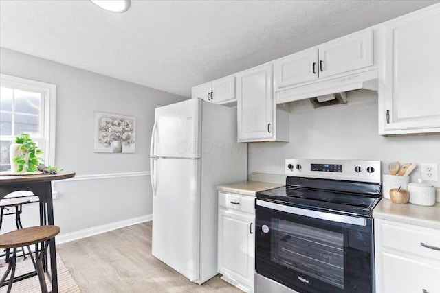 kitchen with white cabinetry, stainless steel range with electric stovetop, white fridge, light hardwood / wood-style floors, and a textured ceiling