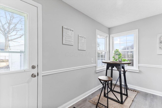 doorway featuring hardwood / wood-style flooring and a textured ceiling