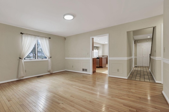 unfurnished room with light wood-type flooring