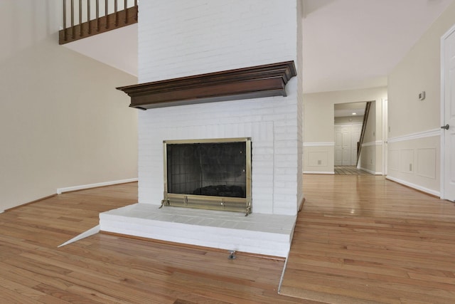 details featuring a brick fireplace and wood-type flooring