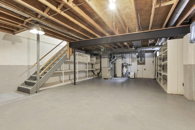 basement with heating unit, electric panel, and water heater