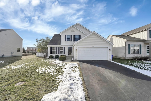 front of property with a garage and a front yard