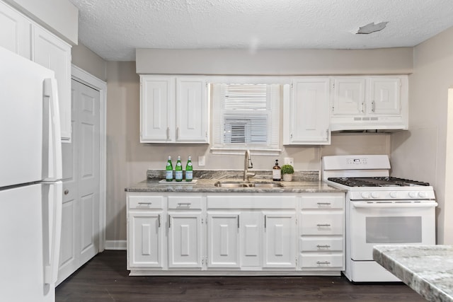 kitchen with sink, white appliances, dark wood-type flooring, and white cabinets