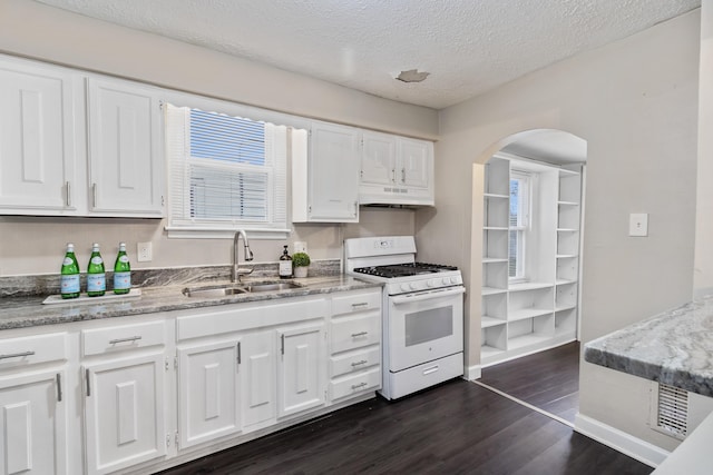 kitchen featuring dark hardwood / wood-style floors, sink, white cabinets, white gas range oven, and a textured ceiling