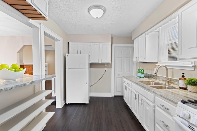 kitchen featuring white cabinetry, sink, light stone counters, dark wood-type flooring, and white appliances