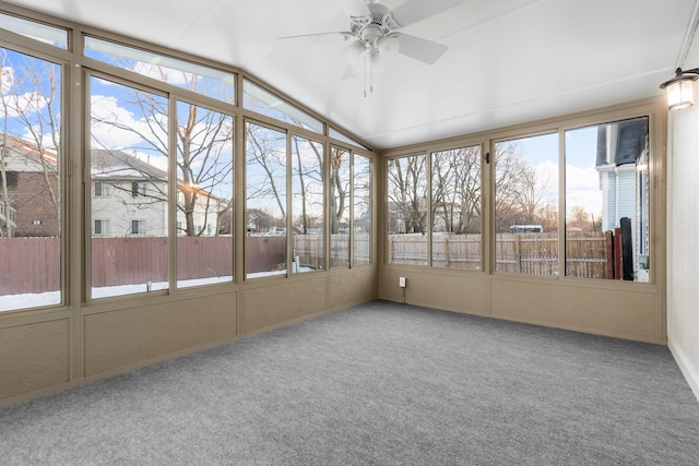 unfurnished sunroom with ceiling fan and vaulted ceiling