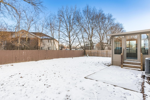 yard covered in snow featuring central air condition unit