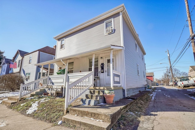 view of front of property featuring cooling unit and a porch